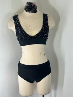 a female mannequin wearing a black bra and shorts