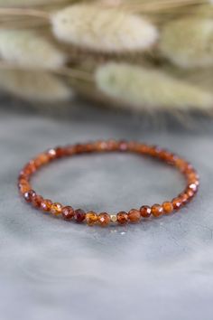 Add a touch of elegance to any outfit with the Shine Hessonite Garnet Gold Bracelet. This stretchy bracelet features solid natural stones that are meant to be layered and stacked for a chic look. Whether it's a casual day out or a special occasion, this bracelet is the perfect accessory. Moonstone Necklace Silver, Mars Chocolate, Garnet And Gold, Hessonite Garnet, Chic Look, Stretchy Bracelets, Orange Gold, Metal Bracelets, Stretch Bracelets