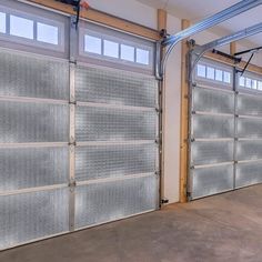 two garage doors are open in an empty room