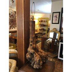 a large piece of wood sitting on top of a wooden table next to a mirror