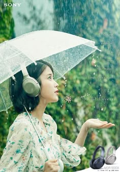 a woman with headphones holding an umbrella in the rain