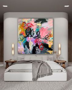 a large painting on the wall above a bed in a room with white walls and carpet