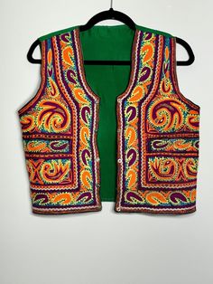 Made in Afghanistan, this a rare find vintage sleeveless waistcoat. Hand embroidery on velvet. A very antique piece in mint condition.  Please contact for exact measurements. Note: Worn and minor signs of wear. Embroidered Festival Vest, Embroidered Sleeveless Vest For Festival, Bohemian Embroidered Vest For Festivals, Festival Vest With Intricate Embroidery, Fitted Multicolor Embroidered Vest For Festival, Vintage Embroidered Fitted Vest, Festive Sleeveless Vest With Multicolor Embroidery, Fitted Vintage Vest With Embroidery, Traditional Sleeveless Festive Vest