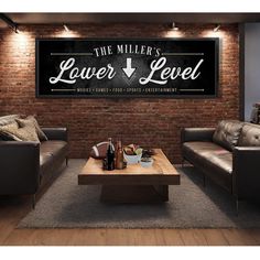 a living room with two couches and a table in front of a brick wall