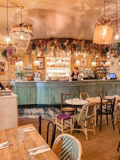 the inside of a restaurant with tables and chairs