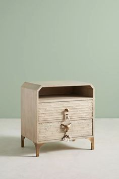 a wooden cabinet with two drawers on one side and an open drawer on the other