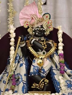 the statue is decorated with flowers and beads