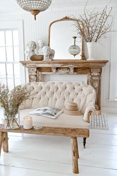 a living room with a couch, table and vases on the top of it