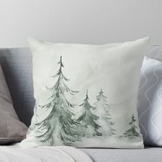 a watercolor painting of pine trees on a white background throw pillow by artist and photographer laura radwell