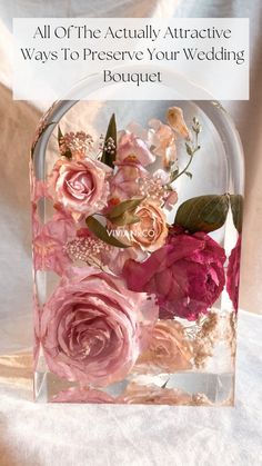 a clear vase with pink flowers inside of it