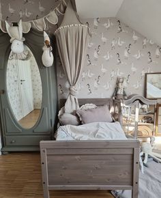 a bedroom with a bed, dresser and mirror