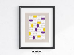 a framed art print with an abstract geometric design in yellow, purple and grey colors