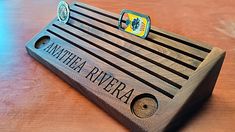 a wooden business card holder sitting on top of a table with the name amatera rivera written on it