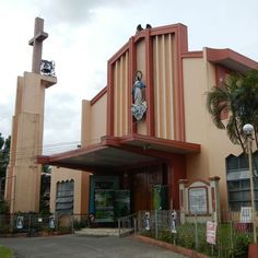 a large building with a statue on the front and side of it's entrance