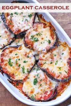 eggplant casserole in a white dish with cheese and parsley on top