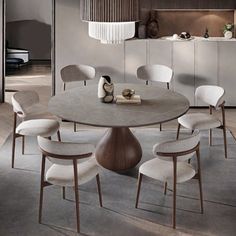 a round table with six chairs around it in a dining room, next to an open kitchen area