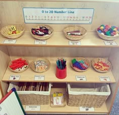 there are many baskets on the shelves with numbers and things to write or draw in them