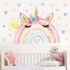 a child's bedroom with a wall mural featuring a pink unicorn and rainbow