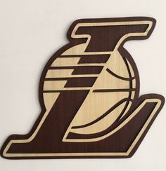 a wooden ornament with the logo of a basketball team on it's side