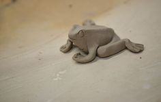 a clay animal laying on top of a table