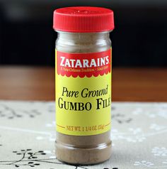 a jar of ground cumbo fill sitting on top of a tablecloth covered table