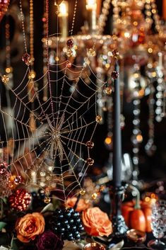 a table topped with lots of candles and spider webs on top of each other