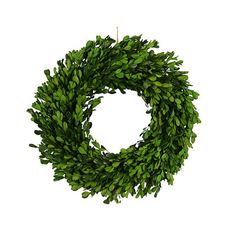 a wreath with green leaves hanging from it