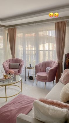 a living room with pink furniture and curtains