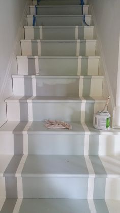 the stairs are painted with white and gray stripes