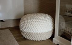 a white stool sitting on top of a tiled floor