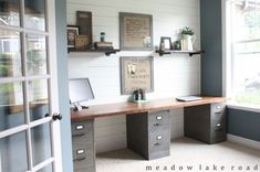 an office with two desks in front of a window and open doors leading to the outside