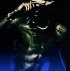 a blurry image of a man with his hands on his head in the dark