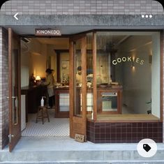 a store front with the door open and some people in it's kitchen area