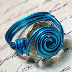 Handmade Wire-Wrapped Ring with blue colored wire and a Faceted clear large-hole, pandora style bead.   Wire is hypo-allergenic and will not tarnish.  If ring loses its shape, it can easily be bent back into place.  Size 7 Coffee Express, Bead Wire, Pink Jewels, Wire Wrapped Ring, Golden Ring, Handmade Wire Wrapped, Pandora Style, Wire Wrapped Rings, Handmade Wire