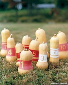 a row of fire hydrants sitting on top of a grass covered field next to each other