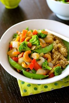 a white bowl filled with vegetables and rice