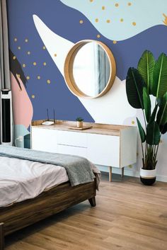 a bed room with a neatly made bed and a large round mirror on the wall