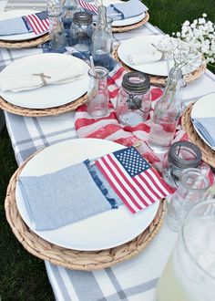 the table is set with plates, napkins and glasses on it for an american flag theme