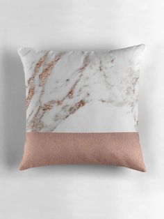 a white and pink marble pillow on a wall