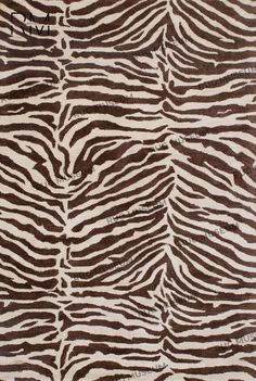 an animal print rug with brown and white stripes