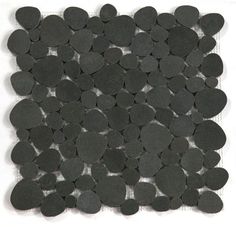 a pile of black circles sitting on top of a white surface