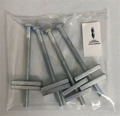 four screws are sitting in a plastic bag