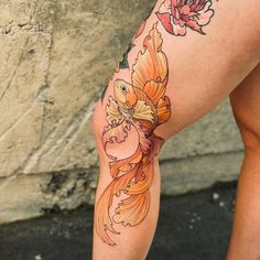 a woman's legs with tattoos and flowers on them