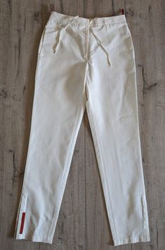 Prada Pants Vintage Women's White Pants  Made in Italy  Velcro fastener 60% cotton 40% nylon IT size 40 Dimensions: Length 99 cm 38.97 inches Thallium 34 cm 13.38 inches Hip 47cm 18.50in Under front, back 25-35cm 9.84-13.77 inches Inseam pitch 75 cm 29.52 inches Top leg width 28 cm 11.02 inches bottom 15 cm 5.90" In excellent used condition White Chinos For Spring Workwear, White Spring Workwear Chinos, Elegant White Cotton Chinos, White Chinos For Workwear In Summer, White Chinos For Summer Workwear, White Summer Chinos For Workwear, White Straight-leg Chinos For Work, White Tapered Leg Chinos For Work, White Straight Leg Chinos For Work