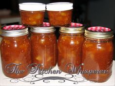 six jars filled with food sitting on top of a table