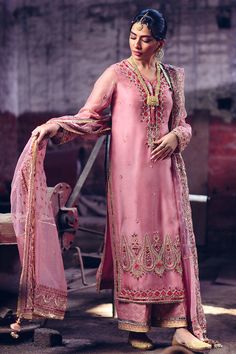 Pakistani Wedding Tea Pink Salwar Kameez Dress has a premium raw silk fabric. The hand-crafted details of embroidery and adornments give a glamorous touch to this breathtaking Traditional attire to wear at any wedding festivity. This perfectly stitched Salwar Kameez gives you your desired dreamy look at the event. Kameez: Beautiful Raw Silk kameez in alluring tea pink shade is gracefully emblazoned with embroidery, tilla, resham, and dabka. The lavish work of gota and sitara enhance the overall Pink Salwar Kameez, Silk Kameez, Indian Fashion Trends, Raw Silk Fabric, Dress Salwar Kameez, Muslim Outfits Casual, Wedding Tea, Silk Set, Muslim Outfits