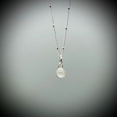 Dainty Moonstone Crystal and sterling silver pendant on a sterling silver satellite chain.  A beautifully polished Moonstone crystal encased in sterling silver (approx. 6mm) on a sterling silver satellite chain. All of our jewellery comes beautifully gift boxed and bagged along with a description of your crystal's benefits. Our jewellery also makes an amazing gift. We are happy to ship this direct for you with a personal message on one of our handprinted cards.  Just let us know you message at c Silver Moonstone Crystal Pendant Necklace, Silver Crystal Necklaces With Birthstone, Moonstone, Moonstone Crystal Necklace, Minimalist Nickel-free Sterling Silver Crystal Necklaces, Nickel-free White Moonstone Necklace, Moonstone Benefits, Sliver Necklace, Nickel-free Moonstone Pendant Jewelry, Moonstone Pendant Necklace