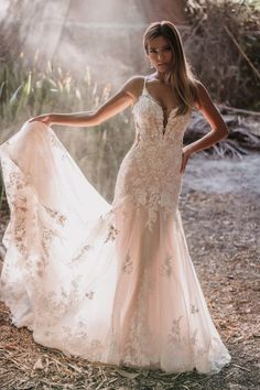 a woman in a wedding dress posing for the camera