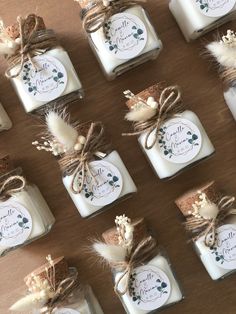 many small jars with labels on them sitting on a table