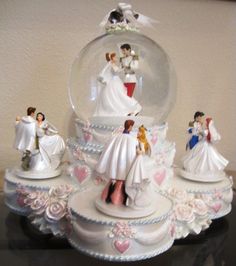 a snow globe with wedding figurines in it